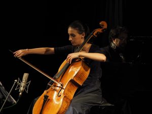 Marina Martins plays the cello with Leandro Roverso by the piano